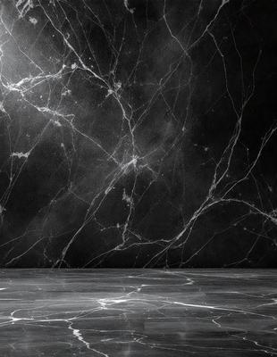 The primary subject of the image is a marble wall with a black background. The setting is a room with a black wall, and the visual style is a photo. The colors and mood of the image are dark and moody, with the marble wall and black background creating a dramatic and sophisticated atmosphere.