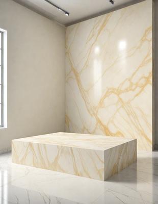 The primary subject of the image is a marble countertop. The setting is a room with a marble wall, and the visual style is a photo. The colors and mood of the image are predominantly white, giving it a clean and elegant appearance.