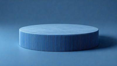 The primary subject of the image is a blue circular object, which appears to be a table or a piece of art. The setting is a blue background, which complements the blue circular object. The visual style is a close-up of the circular object, showcasing its details. The colors and mood of the image are predominantly blue, creating a calm and serene atmosphere.