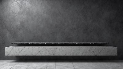 The primary subject of the image is a marble countertop. The setting is a room with a gray wall behind the countertop. The visual style is a photo, and the colors and mood are predominantly gray and neutral.