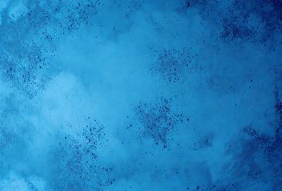 The primary subject of the image is a blue cloudy sky. The setting is a cloudy blue background, which creates a moody atmosphere. The visual style is a photo, capturing the beauty of the cloudy sky. The colors and mood are predominantly blue, with some white clouds adding contrast to the scene.