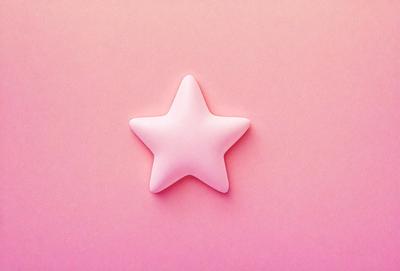 The primary subject of the image is a pink star-shaped object. The setting is a pink background, which creates a warm and inviting atmosphere. The visual style is a close-up of the pink star, emphasizing its shape and texture. The colors and mood of the image are predominantly pink, giving it a soft and gentle appearance.