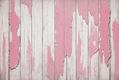 The primary subject of the image is a pink and white wooden wall. The setting is a room with a pink and white painted wall. The visual style is a photo of the wall. The dominant colors are pink and white, creating a warm and inviting atmosphere.