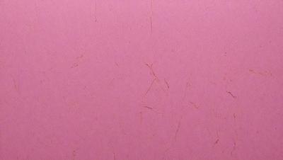 The primary subject of the image is a pink paper with a pattern of white lines. The setting is a pink background, and the visual style is a close-up of the paper. The colors and mood of the image are predominantly pink, creating a warm and inviting atmosphere.