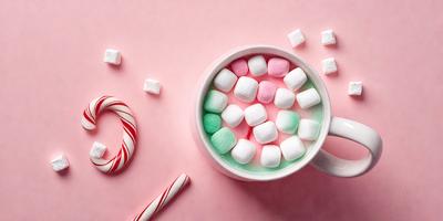 The primary subject of the image is a cup filled with marshmallows, which are white and pink in color. The cup is placed on a pink surface, creating a visually appealing contrast. The marshmallows are arranged in a circular pattern, giving the cup a unique and playful appearance. The overall atmosphere of the image is cheerful and fun, as the marshmallows evoke a sense of relaxation and enjoyment.