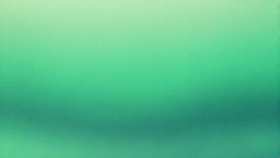 The primary subject of the image is a large, bright green surface. The setting appears to be a dark room, with the green surface being the main focus. The visual style of the image is a photo, capturing the vibrant green color and the dark room. The colors and mood of the image are predominantly green, creating a lively and energetic atmosphere.