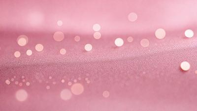 The primary subject of the image is a pink surface with a pattern of white dots. The setting appears to be a pink background, and the visual style is a close-up of the pink surface with the white dots. The colors and mood of the image are predominantly pink and white, creating a soft and delicate atmosphere.