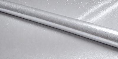 The primary subject of the image is a silver or metallic object, which appears to be a piece of a silver tube or a silver wire. The setting is a white background, which provides a clean and minimalistic environment for the object. The visual style of the image is a close-up of the silver object, showcasing its details and texture. The colors and mood of the image are predominantly silver and white, giving it a sleek and modern appearance.