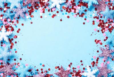 The primary subject of the image is a blue circle with a white background. The circle is surrounded by a variety of red and pink glittery balls, creating a visually appealing and festive atmosphere. The setting appears to be a creative and artistic environment, possibly a digital art or illustration. The colors and mood of the image are predominantly warm and vibrant, with the blue circle and red glittery balls providing a sense of depth and contrast.
