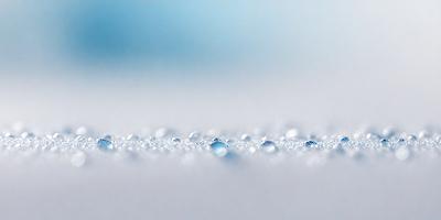 The primary subject of the image is a close-up of a white surface with a pattern of tiny bubbles. The setting is a white background, and the visual style appears to be a photo. The colors and mood of the image are predominantly white, giving it a clean and minimalist appearance.
