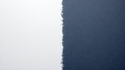 The primary subject of the image is a white wall with a blue background. The setting is a room with a white wall and a blue background. The visual style is a digital art or illustration, as the image features a pattern of blue and white dots. The colors and mood of the image are predominantly blue and white, creating a calm and serene atmosphere.