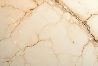The image features a marble countertop with a white and brown color scheme. The countertop has a marble texture, giving it a natural and elegant appearance. The setting is a kitchen or bathroom, as the countertop is a common surface in these areas. The visual style of the image is a close-up of the marble countertop, showcasing its unique texture and beauty. The colors and mood of the image are warm and inviting, creating a sense of luxury and sophistication.