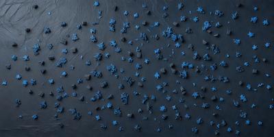 The primary subject of the image is a blue star pattern. The setting is a black background, and the visual style appears to be a digital art or illustration. The dominant colors are blue and black, creating a calm and serene atmosphere.
