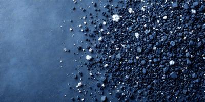 The primary subject of the image is a close-up of a blue surface with white specks on it. The setting appears to be a blue table or a blue background. The visual style of the image is a close-up of the blue surface with white specks, which gives it a textured and detailed appearance. The colors and mood of the image are predominantly blue and white, creating a calm and serene atmosphere.