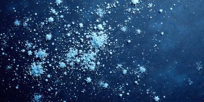 The primary subject of the image is a snowy scene with a blue background. The setting appears to be a night sky, and the visual style is a combination of photo and digital art. The dominant colors are blue and white, creating a serene and peaceful atmosphere. The image features a large number of snowflakes scattered throughout the sky, adding to the overall beauty and tranquility of the scene.
