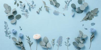 The primary subject of the image is a collection of flowers, leaves, and branches arranged on a blue wall. The setting is a wall with a blue background, and the visual style appears to be a combination of a photo and digital art. The colors and mood of the image are predominantly blue, creating a calm and serene atmosphere.