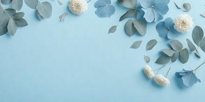 The primary subject of the image is a blue wall with white flowers and green leaves scattered across it. The setting is a room with a blue background, and the visual style is a photo. The dominant colors are blue and white, creating a calm and serene atmosphere.