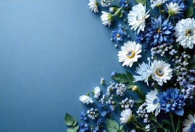 The primary subject of the image is a beautiful arrangement of white and blue flowers. The flowers are arranged in a pattern, creating a visually appealing display. The setting is a blue wall, which serves as a stunning backdrop for the flowers. The visual style of the image is a close-up of the flowers, showcasing their intricate details and textures. The colors and mood of the image are predominantly white and blue, giving it a serene and calming atmosphere.