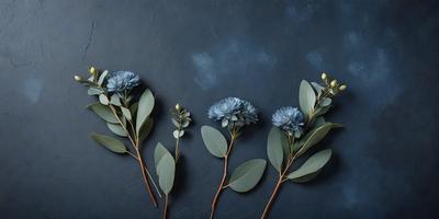 The primary subject of the image is a bouquet of three blue flowers, each with a green leaf, arranged on a blue background. The flowers are placed in a vase, and the overall atmosphere is serene and calming. The visual style of the image is a photo, capturing the beauty of the flowers and their surroundings.