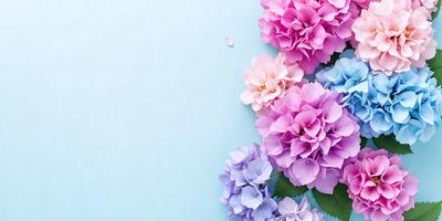 The primary subject of the image is a bouquet of flowers, which are purple and pink in color. The flowers are arranged in a visually appealing manner, creating a sense of beauty and elegance. The setting is a blue background, which complements the colors of the flowers and adds to the overall aesthetic of the image. The visual style of the image is a close-up, allowing the viewer to appreciate the details of the flowers and their arrangement. The colors and mood of the image are predomin