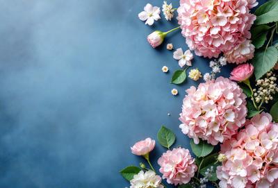 The primary subject of the image is a bouquet of pink flowers, which are the main focus of the scene. The flowers are arranged on a blue surface, which serves as the background. The visual style of the image is a close-up of the flowers, showcasing their details and beauty. The colors of the flowers are predominantly pink, creating a warm and inviting atmosphere.