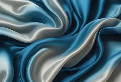 The primary subject of the image is a blue fabric, possibly a piece of silk, with a flowing and swirling pattern. The setting is a blue background, which complements the blue fabric. The visual style is a combination of a photo and digital art, creating a unique and artistic representation of the fabric. The colors and mood of the image are predominantly blue, giving it a calm and serene atmosphere.