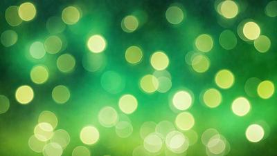 The primary subject of the image is a green background with a pattern of bright, glowing lights. The setting appears to be a dark room, and the visual style is a combination of a photo and digital art. The colors and mood of the image are predominantly green, with the glowing lights creating a warm and inviting atmosphere.