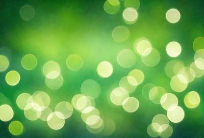 The primary subject of the image is a close-up of a green plant with bright green leaves. The setting is a brightly lit environment, possibly a greenhouse or a well-lit room. The visual style is a close-up of the plant, with a focus on the leaves and their vibrant green color. The colors and mood of the image are lively and fresh, with the green leaves creating a sense of growth and vitality.