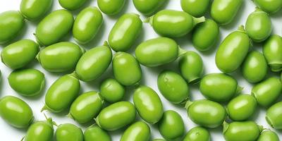 The primary subject of the image is a large group of green beans, which are the main objects in the scene. The beans are arranged on a white surface, which serves as the background. The visual style of the image is a close-up of the green beans, showcasing their texture and details. The colors in the image are predominantly green, which gives the scene a fresh and natural atmosphere.