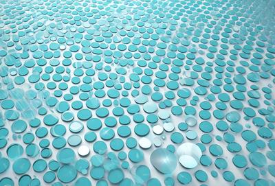 The primary subject of the image is a large number of blue circles arranged in a pattern. The setting is a blue background, which creates a visually appealing contrast with the circles. The visual style is a combination of a photo and digital art, as the circles appear to be digitally created and arranged. The dominant colors are blue and white, giving the image a calm and serene atmosphere.