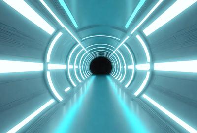 The primary subject of the image is a long, brightly lit tunnel with a blue glow. The tunnel appears to be a futuristic, high-tech passage, possibly a part of a space station or a subway system. The setting is a dark, enclosed space, and the visual style is a combination of a photo and digital art, creating a unique and captivating atmosphere. The dominant colors are blue and white, giving the scene a sense of depth and sophistication.