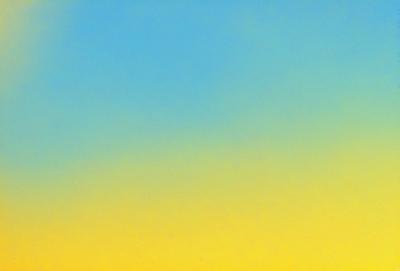 The primary subject of the image is a blue and yellow sky. The setting is a cloudy day, with the sky being the main focus of the image. The visual style is a natural, outdoor scene. The dominant colors are blue and yellow, creating a warm and inviting atmosphere.