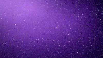 The primary subject of the image is the night sky, which is filled with stars. The setting is a dark, purple background that contrasts with the bright stars. The visual style is a photo of the night sky, capturing the beauty of the celestial bodies. The colors and mood of the image are predominantly purple, creating a serene and peaceful atmosphere.