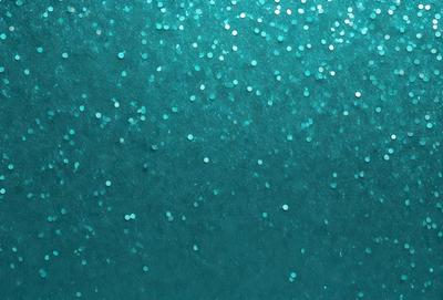 The primary subject of the image is a blue background with a pattern of white stars. The setting appears to be a dark room, and the visual style is a close-up of the blue background with the white stars. The colors and mood of the image are predominantly blue and dark, creating a sense of depth and mystery.