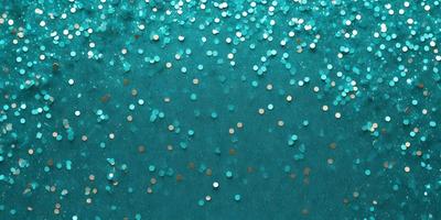 The primary subject of the image is a close-up of a blue background with a pattern of glittering gold stars. The setting appears to be a dark blue surface, possibly a wall or a piece of fabric. The visual style of the image is a combination of a photo and digital art, as the gold stars have a digital appearance while the background is a real-life blue surface. The colors and mood of the image are predominantly dark blue and gold, creating a sense of depth and sophistication.