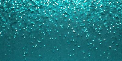 The primary subject of the image is a close-up of a blue background with a pattern of blue and white glittery dots. The setting appears to be a dark blue ocean, with the glittery dots creating a visually appealing and unique pattern. The visual style of the image is a close-up of the blue and white glittery dots, which gives the impression of a digital art or illustration. The colors and mood of the image are predominantly dark blue and white, with the glitter