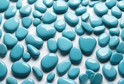 The primary subject of the image is a large collection of blue rocks, which are arranged in a visually appealing manner. The setting is a white background, which provides a clean and uncluttered look. The visual style is a combination of photo and digital art, creating a realistic yet artistic representation of the rocks. The dominant colors are blue, which gives the image a calming and serene atmosphere.