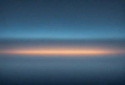 The primary subject of the image is a cloudy sky. The setting is a dark blue background, which creates a dramatic contrast with the cloudy sky. The visual style is a photo, capturing the beauty of the cloudy sky. The colors and mood of the image are predominantly dark and moody, with the clouds casting a shadow on the sky.