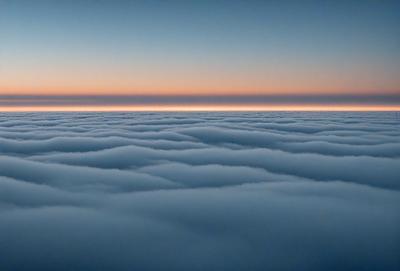 The primary subject of the image is a cloudy sky with a sunset in the background. The setting is a vast expanse of clouds, creating a serene and dramatic atmosphere. The visual style is a photo, capturing the beauty of the cloudy sky and the sunset. The colors and mood are predominantly blue and orange, with the blue of the sky and the orange of the sunset creating a sense of tranquility and warmth.