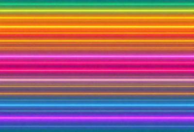 The primary subject of the image is a colorful striped pattern, which is displayed on a purple background. The visual style of the image is a combination of photo and digital art, creating a vibrant and lively atmosphere. The dominant colors in the image are purple and pink, with the striped pattern adding a sense of depth and movement to the overall composition.