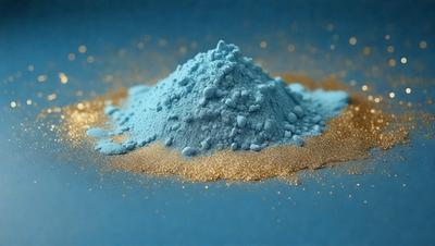 The primary subject of the image is a blue substance, possibly a powder or a blue-colored material, sitting on a blue surface. The setting appears to be a table or a similar surface, with the blue substance being the main focus of the image. The visual style of the image is not explicitly clear, but it could be a photo, digital art, illustration, drawing, pattern, texture, or clipart. The dominant colors in the image are blue and gold, creating a visually appealing and contrasting scene