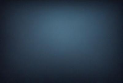 The primary subject of the image is a blue background. The setting is a dark, empty space with no visible objects or people. The visual style is a simple, monochromatic design. The colors and mood are predominantly dark and moody, with the blue background creating a sense of depth and mystery.