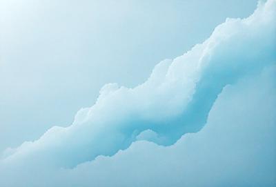 The primary subject of the image is a cloud, which is the main object, scene, or focus of the image. The cloud is set against a blue sky, creating a serene and peaceful atmosphere. The visual style of the image is a photo, capturing the beauty of the cloud in its natural environment. The dominant colors in the image are blue and white, which contribute to the overall mood of the scene.