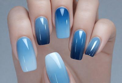 The primary subject of the image is a person's hand holding a blue and white nail polish bottle. The setting is a close-up of the hand and the bottle, with a focus on the nail polish. The visual style is a photo, and the colors and mood are predominantly blue and white, with a touch of gray.