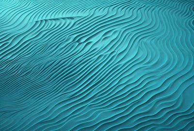 The primary subject of the image is a large body of blue water with a wave pattern. The setting is a vast ocean, and the visual style is a photo. The dominant colors are blue and white, creating a serene and calming atmosphere.