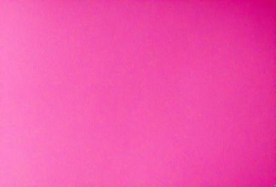 The primary subject of the image is a large, pink wall. The setting is a room with a pink background, and the visual style is a close-up of the wall. The dominant colors are pink, and the overall atmosphere is bright and vibrant.