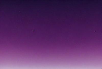 The primary subject of the image is a bright star in the night sky. The setting is a dark, purple-colored sky, which creates a dramatic and moody atmosphere. The visual style of the image is a photo, capturing the beauty of the star against the backdrop of the night sky. The colors and mood of the image are dominated by the purple hue of the sky, which adds a sense of mystery and serenity to the scene.