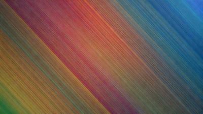 The primary subject of the image is a colorful, swirling pattern that appears to be a digital art or illustration. The setting is a colorful background, possibly a rainbow, which adds to the vibrant atmosphere of the scene. The visual style is a mix of photo and digital art, creating a unique and eye-catching pattern. The dominant colors in the image are red, orange, and blue, which contribute to the lively and energetic mood of the scene.
