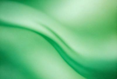 The primary subject of the image is a green, flowing, and swirling pattern. The setting is a green background, which complements the vibrant green color of the pattern. The visual style is a digital art or illustration, as the pattern appears to be a digital creation. The colors and mood of the image are predominantly green, creating a calm and soothing atmosphere.