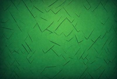 The primary subject of the image is a green background with a pattern of cut-out shapes. The setting is a close-up of the green background, which appears to be a textured or patterned surface. The visual style is a combination of digital art and illustration, as the cut-out shapes create a unique and artistic appearance. The colors and mood of the image are predominantly green, with a slightly textured or patterned surface that adds depth and interest to the overall composition.